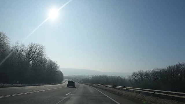 Driving on contry road in sunny day.