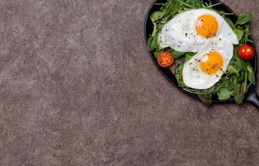 Free space with fried eggs and fresh herbs at pan