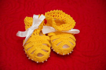 Fototapeta na wymiar yellow Knitted wool shoes for young children