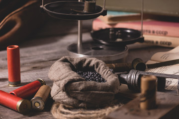 The process of reloading hunting cartridges. On the book are the measurements, twist and fraction for cartridges. The spirit of old traditions.