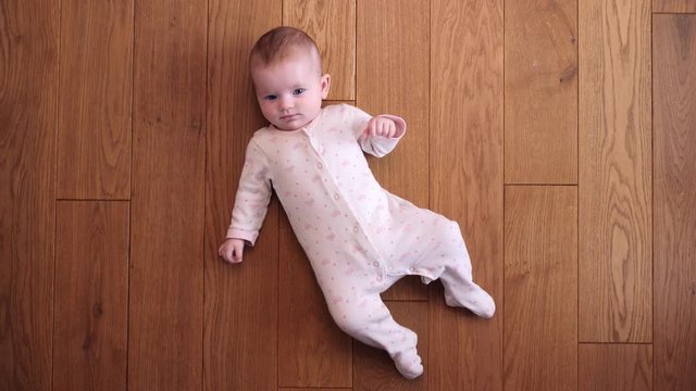 Top view baby child lying on the floor texture at home