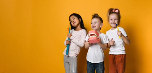 dental hygiene. happy little cute children with toothbrushes.