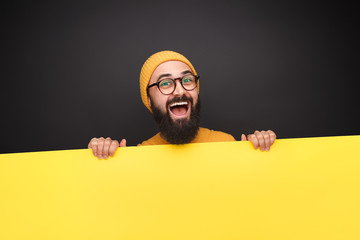 Bright guy with blank yellow poster