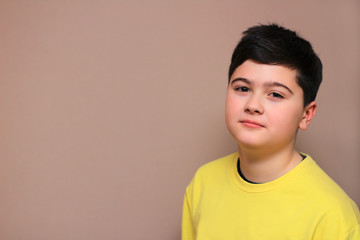 young brown-haired boy on a colored background