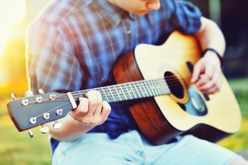 Young man playing guitar - closeup