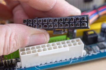The motherboard and computer components. Computer accessories on a workshop table.