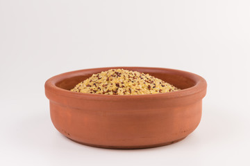 bowl of raw bulgur and quinoa isolated on white background