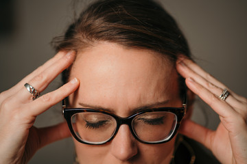 Woman with eyeglasses and headache 