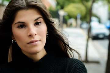 Young woman against wall.