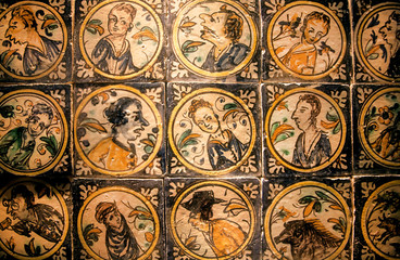 Faces of historical persons on patterned ceramic tiles in traditional style, made in 18th century, Spain