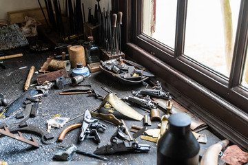 Vintage tools on a bench lit by a window, vice, gunsmith, gun, smith, blacksmith, classic, rusty, colonial era