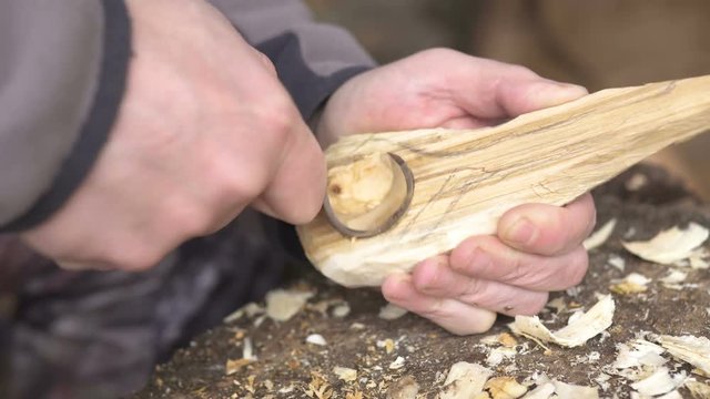 Man carving a wooden spoon
