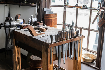 Vintage tools on a bench lit by a window, vice, gunsmith, gun, smith, blacksmith, classic, rusty,...