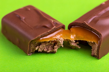 Separated on two pieces tasty chocolate bar with toffee