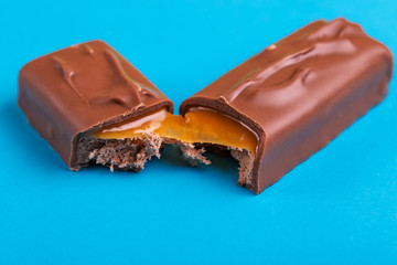 Separated on two pieces tasty chocolate bar with toffee