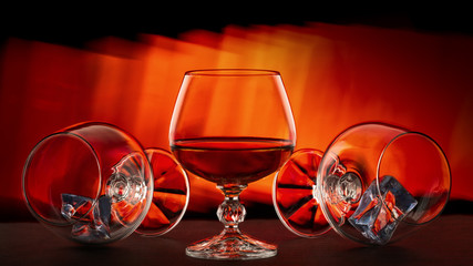 A glass of brandy on a red background