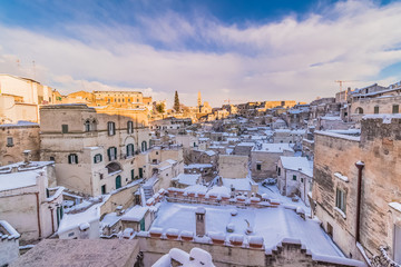 Fototapeta na wymiar panoramic view of Sassi di Matera and church of Matera 2019 under blue sky with clouds and snow on the house, concept of travel and christmas holiday on snowflakes,capital of europe culture 2019