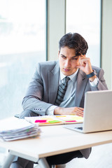 Naklejka premium Young successful businessman working at the office 