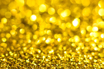 Gold glitter texture. Festive sparkling sequins background. Wpaper for Valentine, New Year or Christmas Holidays.