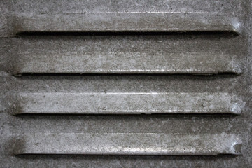 Dust-laden vent opening on an old ferrous closet..