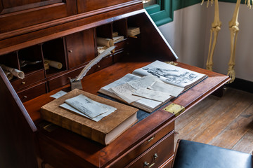 Antique historical medical anatomy textbook on an old desk