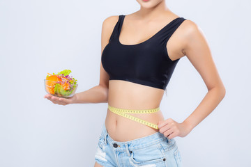 Closeup asian woman holding salad vegetable food and measuring waist for weight isolated on white background, girl diet with cellulite loss with tape measure, health care or wellness concept.