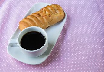 Appetizing bread and cup of coffee on table
