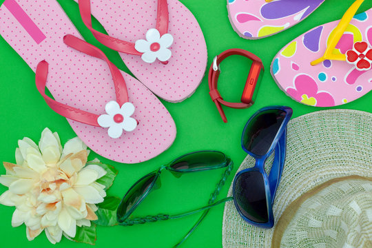 Summer background, set of summer objects and accessories on green background