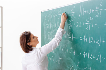 Female math teacher in front of the chalkboard 