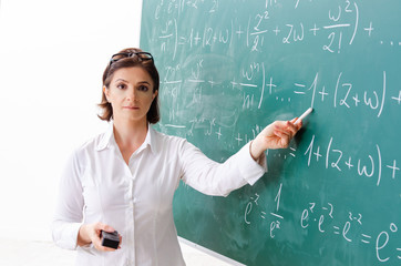 Female math teacher in front of the chalkboard 