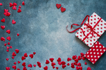 Valentines Day background. Red hearts and gift boxes on blue background. Copy space, top view