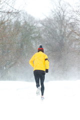 Man running in a heavy snowy day in Dublin,Ireland.