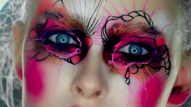Portrait of a woman with colorful paint brushstroken on face
