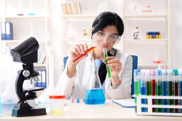 Female chemist working at the lab  