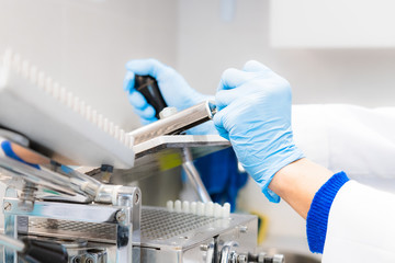 Pharmacist working in laboratory with encapsulator machine