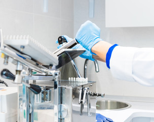 Pharmacist working in laboratory with encapsulator machine