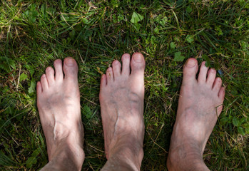 male adult funny feet on green grass