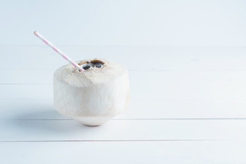 Coconut with a straw isolated on white background.