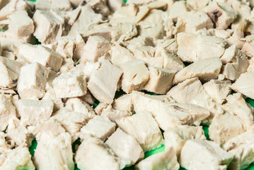 Diced boiled chicken meat on a green board