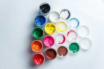 small cans of colorful gouache paint on the whole frame
