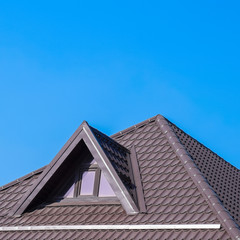 House with plastic windows and a brown roof of corrugated sheet