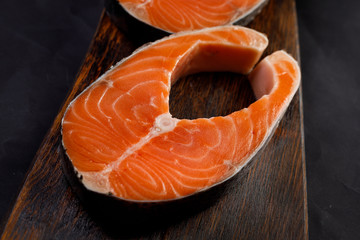 Salmon steak with on wooden plate 