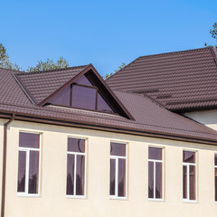 House with plastic windows and roof of corrugated sheet. Roofing