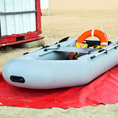 Inflatable Rescue Boat. Gray inflatable boat on the beach in the