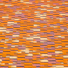 Roof from multi-colored bituminous shingles. Patterned bitumen s
