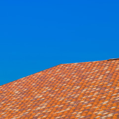 Roof from multi-colored bituminous shingles. Patterned bitumen s