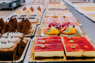many sweets prepared on the metal table of a food factory