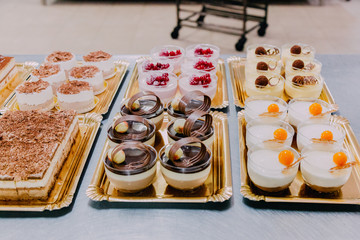 many sweets prepared on the metal table of a food factory