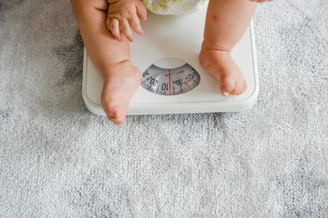 Closeup of a baby's legs on a weighing scale
