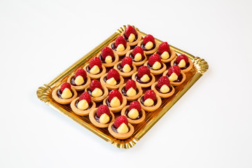 raspberry cupcakes in a tray on white background